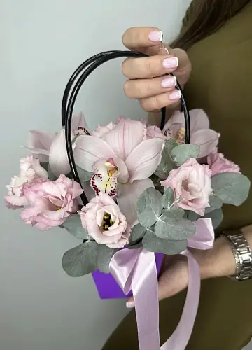 На фото №2 Букет живых цветов с эустомой и орхидеей в сумочке нежного цвета