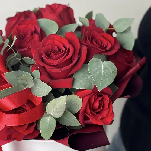 На фото №2 Красные розы в шляпной коробке и зелень